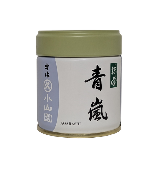 Cylindrical container with a green lid and white label featuring black text on a white background